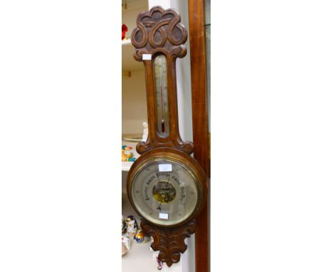 An early 20th Century oak cased barometer and thermometer