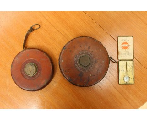 Two early 20th Century leather cased tape measures, together with a Sunwatch compass and sundial, complete with instructions,