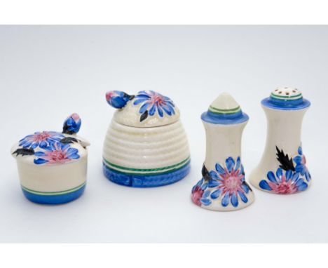 Clarice Cliff for Newport Pottery, a blue 'Marguerite' three piece cruet set and small beehive honey pot (4)