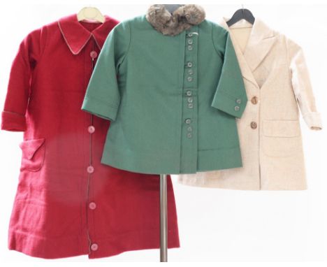 A child's wool mix coat, double breasted (approx. 4 yrs). A bottle green child's coat with side fastenings and buttons in clu