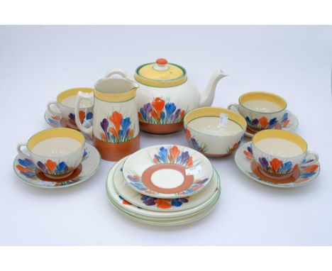 A Clarice Cliff 'Crocus' pattern part teaset, comprising teapot, milk, sugar, four tea cups, five saucers and five plates