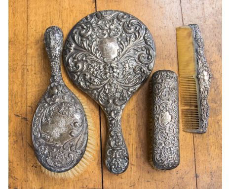 An Edwardian silver four piece dressing table brush set, comprising of clothes brush, hair brush, a mirror and a comb, hallma