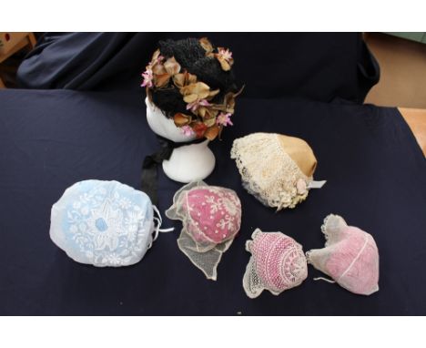 Three babies' bonnets, two tulle and one knitted lace, together with white-worked cotton lawn bonnet, also a straw and bobbin