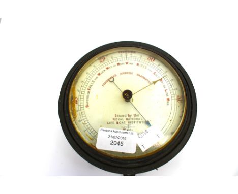 A fisherman's aneroid barometer, the circular white dial inscribed 'Issued by the Royal National Lifeboat Institution No. 185