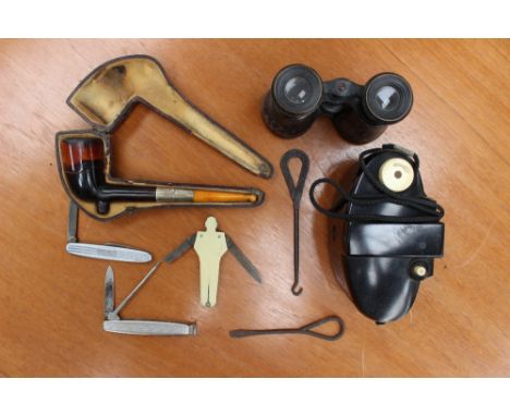 A cased pipe having egg amber mouth piece and silver collar, with three pen knives, having pipe cleaning attachments etc (1 b