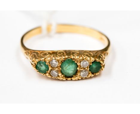 An emerald and diamond 18 ct. gold boathead ring, 3.0 grm approx. size R