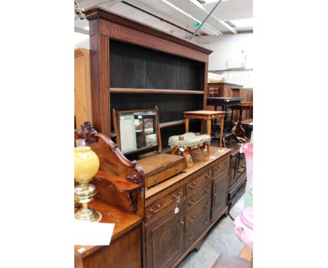 A George III oak dresser and rack, the rack with three plate shelves and six spice drawers, the base section with six drawers