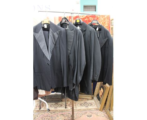 A 1940s dinner jacket and trousers and another 1940s dinner jacket and trousers and a 1930s evening jacket with tails and tro