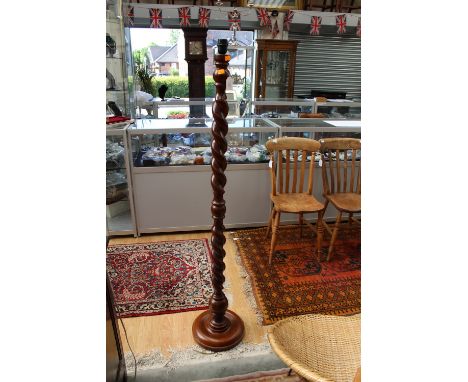 A late 20th Century beech standard lamp, with a barley twist column, raised on  a circular base, measuring 150 cm high
