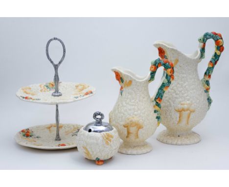 Clarice Cliff for Newport Pottery, 'Celtic Harvest' jugs, preserve pot and two tier cake stand