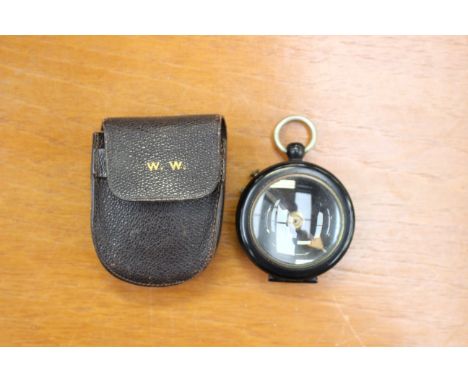 A Negretti & Zambra, London, wartime compass, black with magnifying lens and leather case