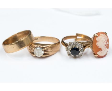 Three 9 ct. gold dress rings to include a cameo, white stone solitaire and a sapphire and diamond set, together with a 9 ct. 