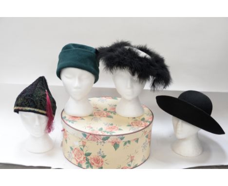 A late 1940s New Look hat with a white woven linen crown and an ostrich feather brim, an Oriental hat in velvet with tassel, 