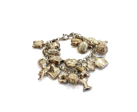 Silver charm bracelet measures approx. 17cm in length.     item is in pre-worn, vintage condition Signs of age and wear to be