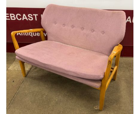 A Danish style teak and pink fabric upholstered sofa 