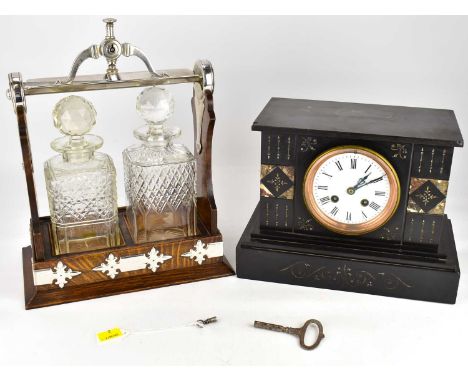 A 19th century black slate mantel clock, the circular white enamelled dial set with Roman numerals, two winding holes and chi