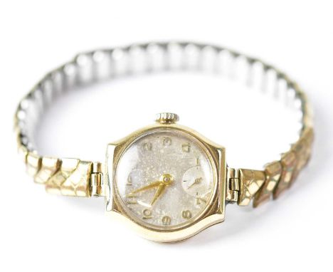 DENNISON; a 9ct yellow gold ladies' wristwatch, the dial set with Arabic numerals, width approx. 27mm, on a gold plated expan