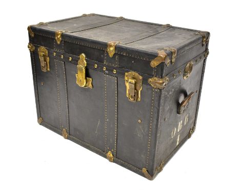 A leather travelling trunk with brass studs and fittings, with leather carrying handles and sides stamped 'OBB1', locks stamp