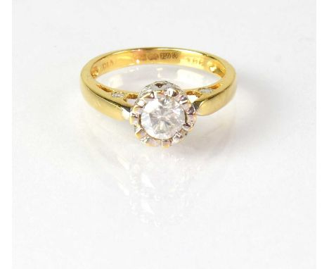 An 18ct yellow gold solitaire diamond ring, the stone in an unusual setting, set with smaller brilliant cut diamonds, and dia