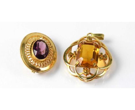 A yellow metal brooch set with an oval amethyst in a filigree frame, together with one other openwork quatrefoil-style pendan