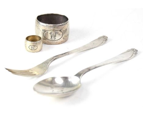 A Dutch silver spoon and a matching fork, together with a large hammered napkin ring and a small example, all with engraved W