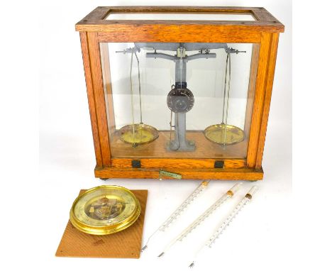 A cased set of school scientific balance scales in oak and glazed cabinet, 38 x 39.5 x 21cm, together with a barometer and th