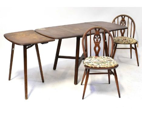 ERCOL; a dark elm drop-leaf dining table with one extra leaf, 72 x 74 x 135cm when extended, and four stick back chairs with 