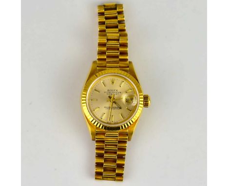 ROLEX; an 18ct yellow gold ladies' Oyster Perpetual Datejust wristwatch, the champagne dial set with baton numerals, date ape