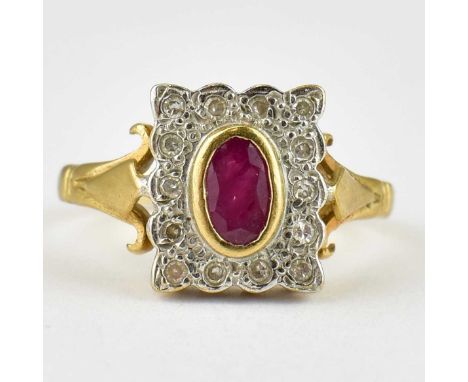 A vintage 9ct gold Art Deco style ring set with central marquise bezel set ruby within a square tablet with a border of small