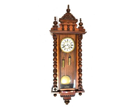 A Vienna mahogany cased wall clock with arched pediment, the ivorine dial set with Roman numerals and secondary dial, with do