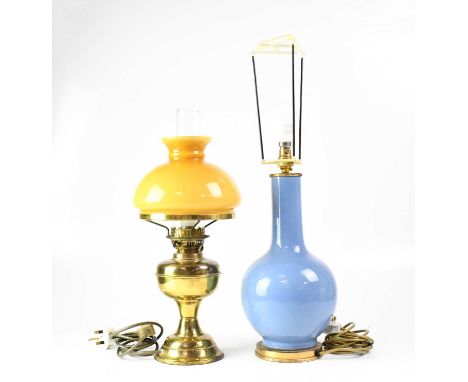 A reproduction oil lamp with mustard-coloured shade, together with a similar example with painted shade, a globe ceiling ligh