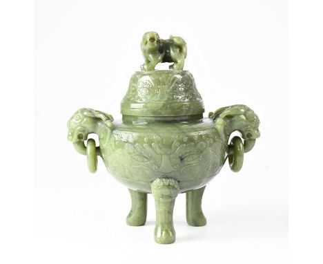 A large Chinese carved mottled jade koro and cover with all-over scroll carved detail and twin mask ring drop handles, raised