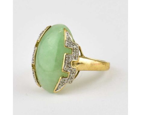 A 9ct gold ring set with oval pale green jade mounted either side with contemporary white stone cluster, size N, approx. 4.6g