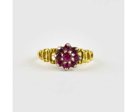 An 18ct gold ring, ruby cluster with three open hoop shoulders, size K, approx. 2.7g.