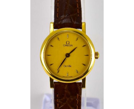 OMEGA; a ladies' 18ct gold wristwatch, the champagne dial set with baton numerals, original Omega leather strap, diameter of 