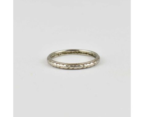 A platinum thin band ring with repeating pattern, size P/Q, approx. 3.5g.