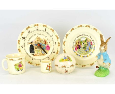 ROYAL DOULTON; five Bunnykins items comprising, wall clock, mug, egg cup, plate and money bank, together with a Beswick cente