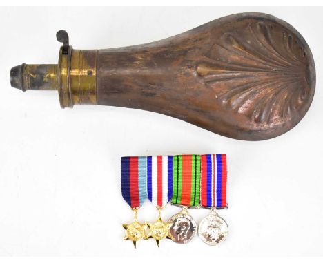 A copper shot flask, together with a modern set of four miniature medals.