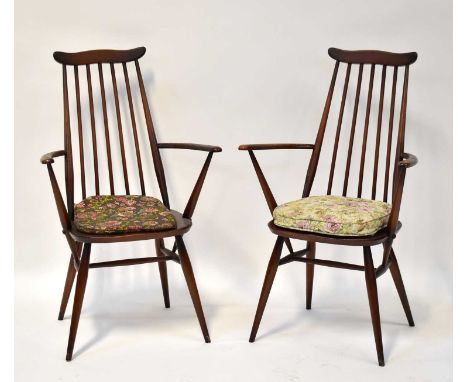 ERCOL; a pair of dark elm stick back open arm dining chairs (2).