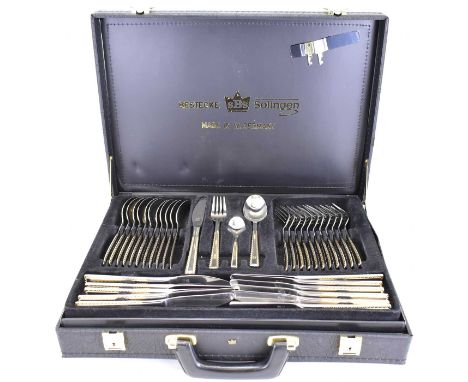 SOLINGEN, WEST GERMANY; a seventy-piece Berlin pattern gilt-heightened cutlery service, in black two-level briefcase, model n