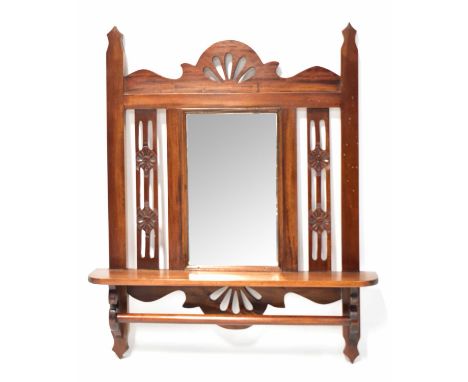 An early 20th century mahogany hall mirror with bevelled plate, pierced decoration, integral shelf and rail, 90 x 66cm.