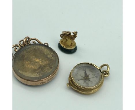 A Small Gold whippet dog seal (green agate), A Small Gold cased compass and 9ct gold (Chester) pendant encased Victorian coin