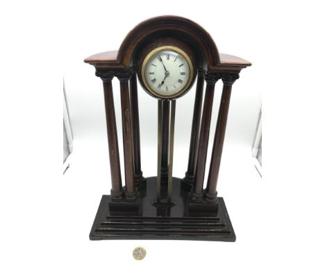 A Victorian rise and fall granite ball cased clock, sat inside a Mahogany column casing. Has hand painted enamel face. Measur