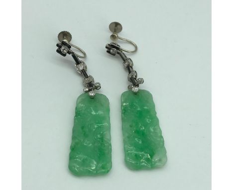 A Pair of white metal Art Deco earrings set with carved jade ingots , Diamonds and black jade style stones. 