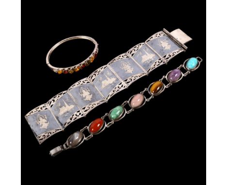 A Thai silver and niello panel bracelet, a silver and oval cabochon stone set panel bracelet, and a silver and amber set pane