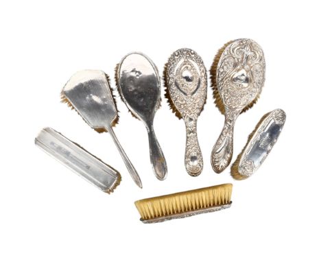 7 various embossed and engine turned silver-backed dressing table brushes