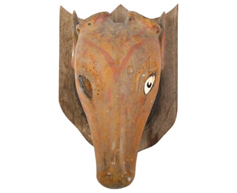 A Folk Art carved and painted wood cow's head on oak shield plaque, overall length 48cm, head length 44cm