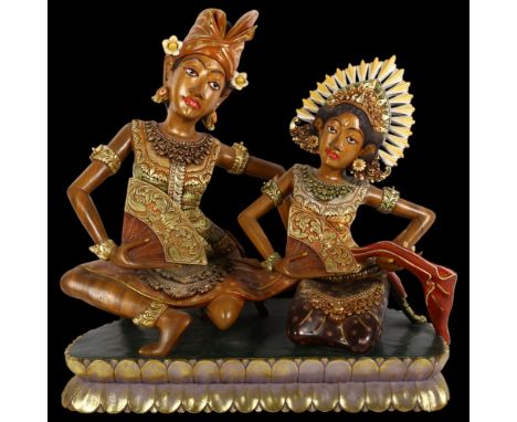 A modern carved wood sculpture of Thai dancers, unsigned, L48cm, H49cm