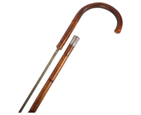 An early 20th century bamboo cased swordstick, with silver collar, blade length 66cm, overall length 83cm.