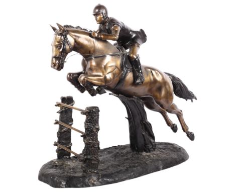 A large bronze group depicting a racing horse and jockey over the jumps, on a textured base, H56cm